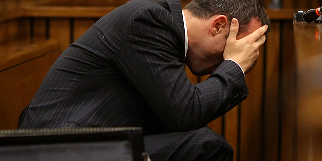 Olympic and Paralympic track star Oscar Pistorius vomits during a hearing on the sixth day of his trial for the 2013 murder of his girlfriend, on March 10, 2014 at the high court in Pretoria. Pistorius, a double amputee known as the 