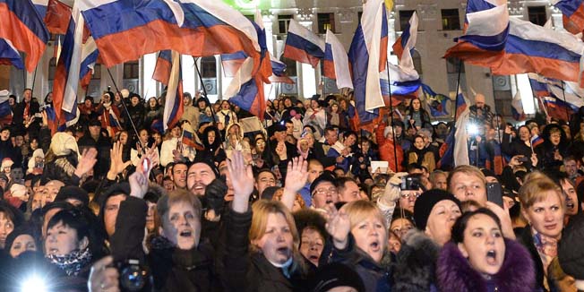 Pro-Russian Crimeans gather to celebrate in Simferopol's Lenin Square on March 16, 2014 after exit polls showed that about 93 percent of voters in Ukraine's Crimea region supported union with Russia. Crimeans voted overwhelmingly to join former political master Russia as tensions soared in the east of the splintered ex-Soviet nation amid the worst East-West crisis since the Cold War.   AFP PHOTO / DIMITAR DILKOFF