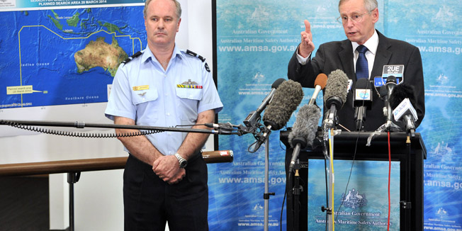 Air Commodore John McGarry (L) listens as John Young, Australian Maritime Safety Aiuthority emergency response general manager, speaks to the media about the discovery from satellite imagery of objects possibly related to the search for the missing Malaysia Airlines flight MH370 in Canberra on March 20, 2014. Two objects possibly related to the search for missing Malaysia Airlines flight MH370 have been sighted by satellite in the remote southern Indian Ocean, Australian officials said, calling it the 