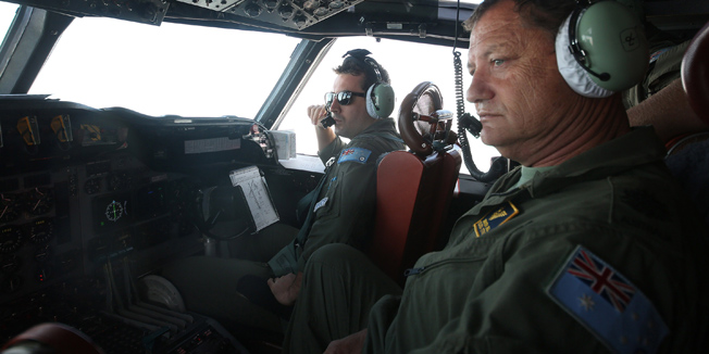 A photo taken on March 21, 2014, shows the crew of a Royal Australian Air Force AP-3C Orion aircraft participating in the Australian Maritime Safety Authority-led search for Malaysia Airlines Flight MH370 in the Southern Indian Ocean. Spotter planes spent a second fruitless day scouring a remote stretch of the Indian Ocean for wreckage from a Malaysian jet.  Australian and US military aircraft usually used for anti-submarine operations criss-crossed the isolated search area 2,500 kilometres (1,500 miles) southwest of Perth, looking for two floating objects that had shown up on grainy satellite photos taken several days before.  AFP PHOTO - POOL / BOHDAN WARCHOMIJ
