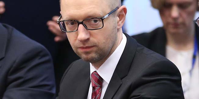 Ukrainian Prime Minister Arseniy Yatsenyuk (2nd-R) meets with EU leaders during the signing of the political provisions of the Association Agreement with Ukraine at the EU headquarters in Brussels on March 21, 2014 on the second day of a two-day European Council summit. Yatsenyuk put his country firmly in the Western camp, signing the political provisions of a landmark association accord with EU leaders in defiance of Russia. AFP PHOTO / POOL / OLIVIER HOSLET