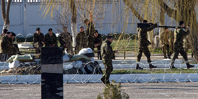 Ukrainian soldiers load weapons and amunition into trucks at the Ukrainian marine battalion in the Crimean city of Feodosia on March 23, 2014. Elite Russian troops firing into the air and backed by armoured vehicles stormed a Ukrainian airbase in Crimea on Saturday as Russia's defiant march across the rebel peninsula rolled on despite sanctions and growing global isolation.AFP PHOTO/ DMITRY SEREBRYAKOV