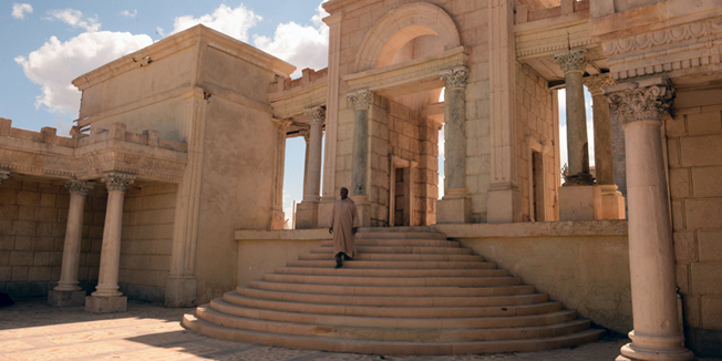 TO GO WITH AFP STORY BY OMAR BROUSKYA general view taken on March 13, 2014 shows a man walking in part of the Tifoultout Kasbah cinema set near Ouarzazate in southern Morocco. Ouarzazate was once dubbed the 