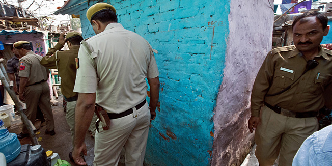 Delhi Police personnel arrive in search of relatives of gang-rape accused Ram Singh who was found hanged in his cell in high security Tihar prison, at his locked shanty in New Delhi on March 11, 2013.  The main accused in the fatal gang-rape of a student on a bus in New Delhi in December 2012, has reportedly been found hanged in jail on March 11, 2013, while in solitary confinement, prompting outrage from the victim's family. Ram Singh, one of six people on trial over the shocking attack, was found dead shortly before dawn after making a noose out of his clothing, according to officials at Delhi's top-security Tihar jail.  AFP PHOTO/ Prakash SINGH