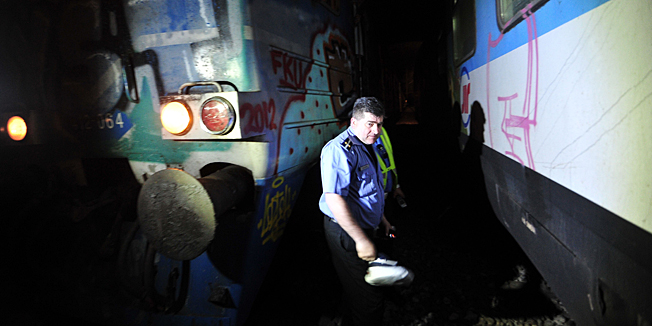 A Serbian policeman inspects the damage caused by train accident in a tunnel on the outskirts of Belgrade on May 2, 2013. Twenty-two people were injured Thursday when two passenger trains collided in a Belgrade tunnel, local media reported.    AFP PHOTO / STR    /SERBIA OUT/