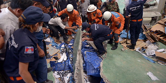 Cambodian rescue team and soldiers look for workers after a factory collapsed in Kampong Speu province, some 50 kilometers west of Phnom Penh on May 16, 2013.  A ceiling collapsed at a shoe factory killing at least two workers, police said, stoking concerns about industrial safety after last month's disaster in Bangladesh.  TOPSHOTS  AFP PHOTO/ TANG CHHIN SOTHY