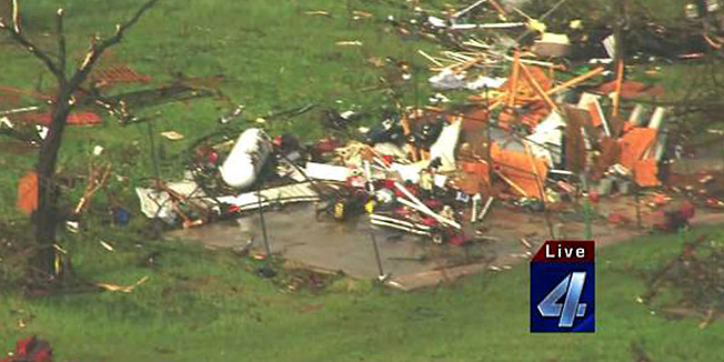 Damaged structures are seen May 19, 2013 after a tornado ripped through Wellston, Oklahoma. Tornadoes damaged many areas across the state May 19, 2013 and are still forming.  Homes have been destroyed, with the worst damage so far just outside of Wellston.   AFP PHOTO / KFOR-TV     == RESTRICTED TO EDITORIAL  USE / MANDATORY CREDIT:  