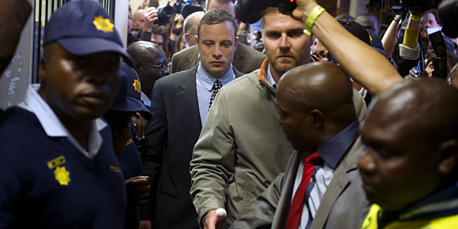 South African Paralympic sprinter Oscar Pistorius (C) leaves on June 4, 2013  the Magistrate Court in Pretoria after appearing for the first time since being freed on bail in February over the Valentine's Day killing of his model girlfriend. The 26-year-old is appearing for a brief pre-trial hearing, with both defense and prosecutors seeking a postponement as police try to wrap up their investigation of the case that grabbed world headlines. The Pretoria magistrate's postponed Pistorius' pre-trial hearing to August 19 for police to wrap up their probe into his Valentines' Day shooting of his girlfriend Reeva Steenkamp.AFP PHOTO / ALEXANDER JOE