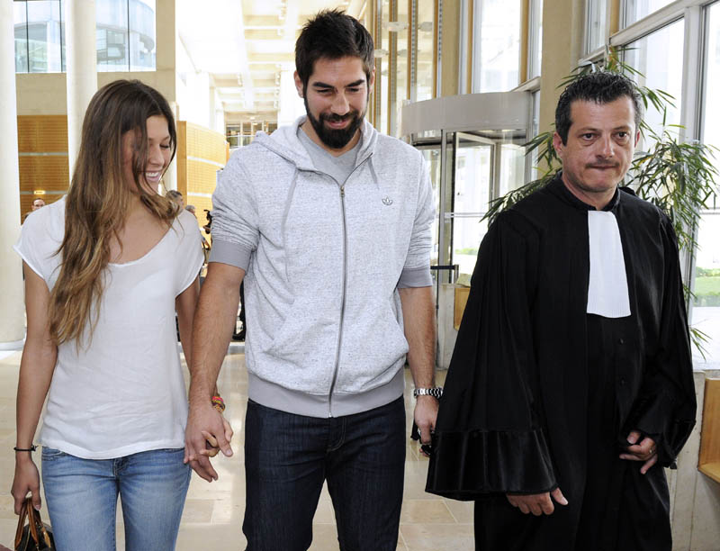 French handball player Nicola Karabatic (C), flanked by his girlfriend Geraldine Pillet (L) and his lawyer Mickael Corbier (R), leaves the Montpellier courthouse on June 10, 2013, after a hearing before a judge in connection with an illegal betting case on the result of a match between league champions Montpellier and Cesson last year. Karabatic, his brother Luka Karabatic and their girlfriends, plus a number of other players and others implicated in the affair, were placed under formal investigation in October 2012 on suspicion of defrauding state-run betting franchise Francaise des Jeux. AFP PHOTO / PASCAL GUYOT
