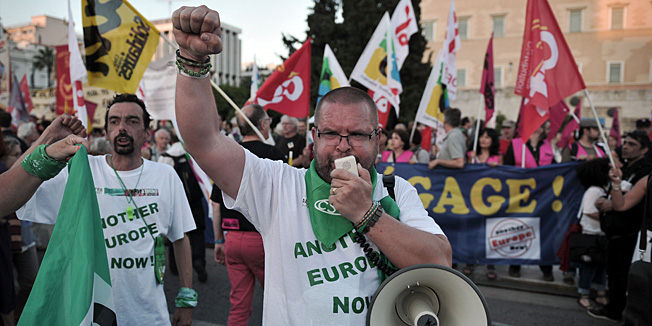 European activists, participants in the Athens Alter Summit, take part in a demonstration in front of the Greek parliament in Athens on June 8, 2013. More than 300 European movements, organisations and unions  joined  forces in a march against austerity, poverty and racism to culminate the Alter Summit, a two-day forum in Athens to protest against stringent cuts applied across the continent, which they see as a vain attempt to promote growth. AFP PHOTO/ LOUISA GOULIAMAKI