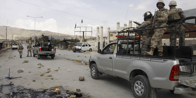 Pakistan paramilitary troops patrol at the site of an attack by gunmen, in Quetta, Pakistan, Saturday, April 14, 2012. Police say gunmen riding on a motorcycle have killed eight Shiite Muslims in a pair of sectarian attacks in southwest Pakistan. (AP Photo/Arshad Butt)