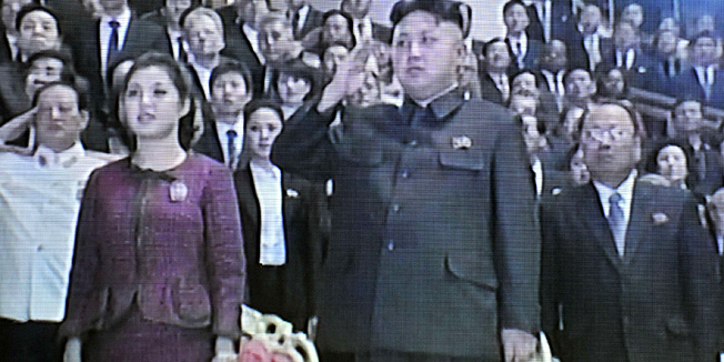 This screen grab taken from North Korean TV on January 3, 2013 shows North Korea's young leader Kim Jong-Un (centre R) and his wife Ri Sol-Ju (centre L) attending a New Year celebration event held in Pyongyang on January 1. North Korea's next dynastic succession may have been secured, with new TV images of leader Kim Jong-Un's wife suggesting that Pyongyang's first lady recently gave birth.  TOPSHOTS   AFP PHOTO/NORTH KOREAN TV      -----EDITORS NOTE --- RESTRICTED TO EDITORIAL USE - MANDATORY CREDIT 