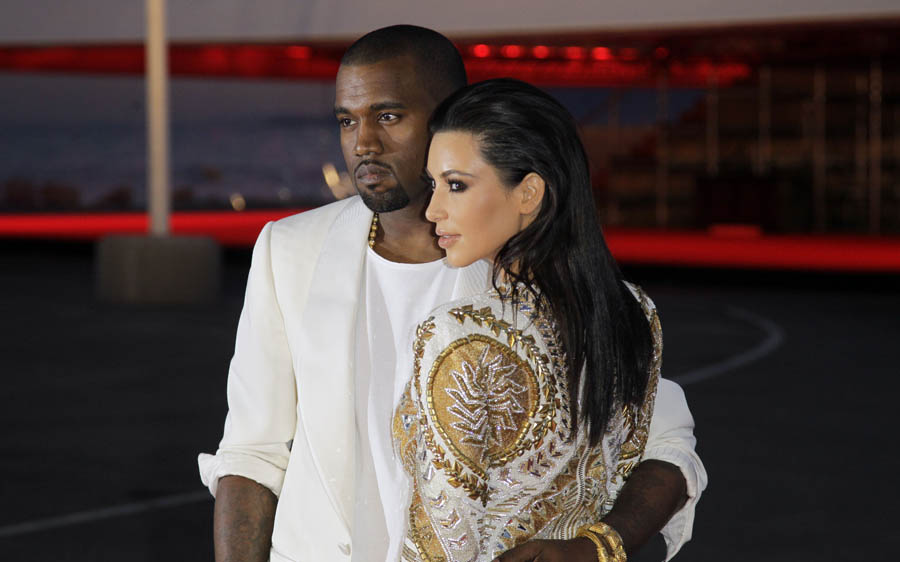 Singer Kanye West, left, and television personality Kim Kardashian arrive for the screening of Cruel Summer at the 65th international film festival, in Cannes, southern France, Wednesday, May 23, 2012. (AP Photo/Francois Mori)