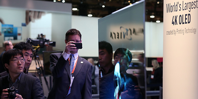 LAS VEGAS, NV - JANUARY 08: Attendees look at a display of the Panasonic 4K OLED 56