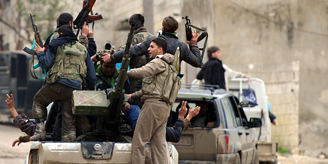 Syrian rebel fighters celebrate after taking over the village of Aljanodiya, northwestern Idlib province, following fighting against pro-Syrian regime forces, on January 30, 2013. Syria's opposition chief Moaz al-Khatib said he is ready for dialogue with officials of President Bashar al-Assad's regime, subject to conditions including that some 160,000 detainees are released. The United Nations says more than 60,000 people have been killed in Syria's 22-month conflict. AFP PHOTO/AAMIR QURESHI