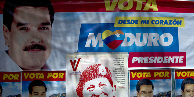 Propaganda posters of of Venezuelan acting President and presidential candidate Nicolas Maduro at Petare slum in Caracas on April 13, 2013.  Venezuela's government mobilized behind Hugo Chavez's image Saturday as the opposition complained that campaign rules were being ignored on the eve of a vote to choose a successor to the late leader..  AFP PHOTO/Raul ARBOLEDA