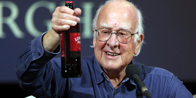British Physicist Peter Higgs recipient of The Nobel Prize for Physics, holds up a bottle of London Pride beer at a press conference in The Playfair Library, Old College, University of Edinburgh on October 11, 2013. The British scientist and his Belgian colleague Francois Englert were jointly awarded the prize on Tuesday for their work on the Higgs Boson particle, discovered last year after an tortuous quest, that explains why the Universe has substance. AFP PHOTO/IAN MACNICOL