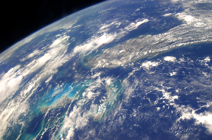 This picture provided by NASA on May 16, 2009 shows a high oblique Earth scene from the STS-125 crew. The view is reminiscent of Gemini 11 photos 43 years ago, because of similar altitudes, approximately 350 statute miles. The Florida peninsula and its neighboring geographic features are easily recognizable beneath the clouds along with the tell-tale change in water color associated with the 