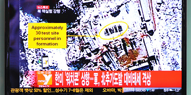 South Korean passengers watch TV news reporting North Korea's apparent nuclear test, at the Seoul train station on February 12, 2013.  North Korea's apparent nuclear test had an explosive yield of between six and seven kilotons, South Korea's defence ministry said, revising its earlier estimate of 10 kilotons or more. Ministry spokesman Kim Min-Seok said seismic monitors had detected a tremor with a 4.9 magnitude emanating from the North's nuclear test site.    TOPSHOTS    AFP PHOTO / KIM JAE-HWAN