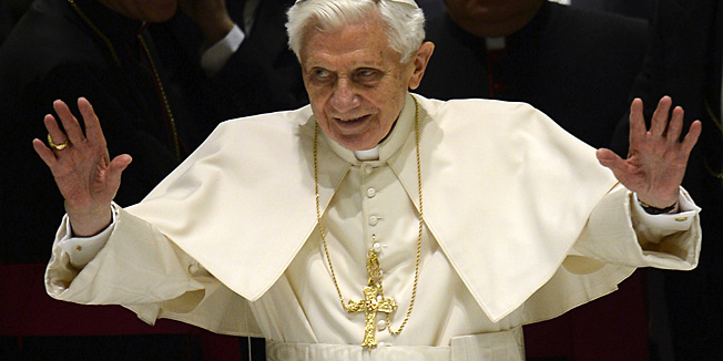 Pope Benedict XVI waves as he arrives for his weekly general audience on February 13, 2013 at the Paul VI hall at the Vatican. Pope Benedict XVI made his first public appearance Wednesday since the shock announcement of his resignation, sticking with his schedule by presiding over his weekly general audience. AFP PHOTO / FILIPPO MONTEFORTE