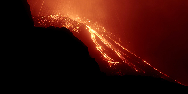 This handout aerial picture released by the Dipartimento Protezione Civile show flanks of the Stromboli volcano,on the Italian island of Stromboli, spewing lava on January 15, 2013 after one of Europe's most active volanoes churned into activity. Stromboli, which attracts up to 6.000 tourists every year, had recently been placed under heightened surveillance after scientists registered higher seismic readings.   AFP PHOTO/ HO /DIPARTIMENTO PROTEZIONE CIVILERESTRICTED TO EDITORIAL USE - MANDATORY CREDIT AFP PHOTO / HAND OUT / Dipartimento Protezione Civile - NO MARKETING NO ADVERTISING CAMPAIGNS - DISTRIBUTED AS A SERVICE TO CLIENTS