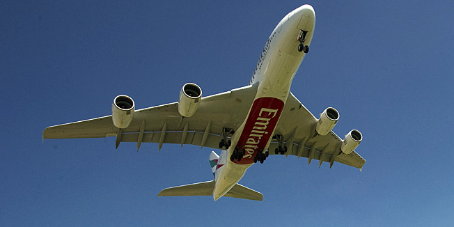 Plane spotters watch as an Emirates flight on an Airbus A380 lands at Amsterdam Airport Schiphol (AMS) on August 1, 2012. This is the first commercial flight of the Airbus A380 to land at AMS. AFP PHOTO / ANP / TOUSSAINT KLUITERS --NETHERLANDS OUT--