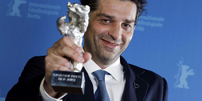 Bosnian director Danis Tanovic poses backstage with his Jury Grand Prix Silver Bear award for his movie 