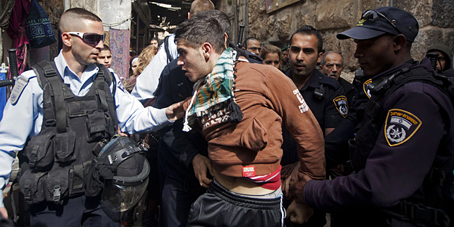 Israeli policemen arrest a Palestinian man in Jerusalems old city, near Al-Aqsa mosque on February 25, 2013 after a group of Israeli settlers attempted to enter the compound on February 25, 2013. Palestinian president Mahmud Abbas said that Israel was deliberately seeking to stoke unrest in the occupied West Bank but that Palestinians would not be provoked. AFP PHOTO/AHMAD GHARABLI
