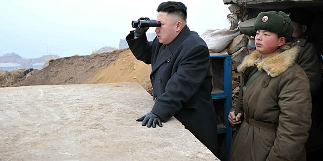 This picture, taken by North Korea's official Korean Central News Agency on March 7, 2013 shows North Korean leader Kim Jong Un (C) using a pair of binocular to look south as he inspects Jangjae Islet Defence Detachment near South Korea's Taeyonphyong Island in South Hwanghae province, North Korea's southwestern sector of the front.   AFP PHOTO / KCNA via KNS ---EDITORS NOTE--- RESTRICTED TO EDITORIAL USE - MANDATORY CREDIT 