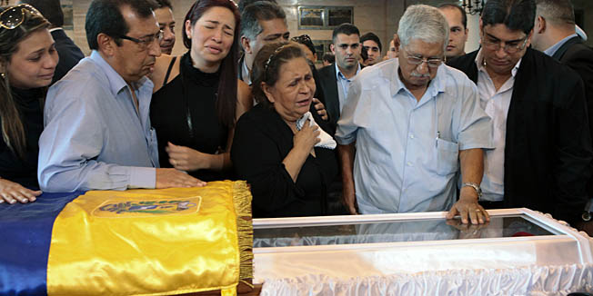 Handout picture released by the Venezuelan presidency showing the parents of  late President Hugo Chavez , Elena Frias and Hugo de los Reyes Chavez (C) and his brothers Adan (L) during his funeral, in Caracas, on March 7, 2013. Late Venezuelan president Hugo Chavez will be moved to a barracks where he will lie in state for longer than had been planned then be embalmed 