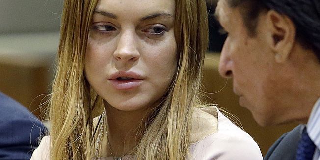 Actress Lindsay Lohan and attorney Mark Heller appears at a hearing in Los Angeles Superior Court on March 18, 2013. The hearing is to determine whether Lohan returns to jail or averts a trial on charges that she lied to police over a June, 2012 car crash that briefly sent her to the hospital. Lohan has pleaded not guilty to three misdemeanor charges filed after the accident - reckless driving, lying to police and obstructing officers from performing their duties.  AfP PHOTO/Reed Saxon/Pool