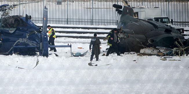 Police officers work at the scene where two police helicopters crashed near the Olympic stadium in Berlin on March 21, 2103. The helicopters crashed as they were landing after a training exercise.AFP PHOTO / JOHANNES EISELE
