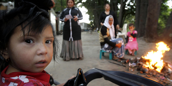 Miluna a young Roma stands in a camp, in Fleury Merogis, south of Paris, Monday, Sept. 6, 2010.  France has stepped up its long-standing policy of rounding up Eastern European Gypsies, or Roma, and sending them home. Officials have dismantled more than 100 illegal camps and expelled hundreds of Roma, mostly to Romania and Bulgaria. (AP Photo/Christophe Ena)
