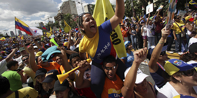 Supporters of opposition Presidential candidate Henrique Capriles cheer during a campaign rally in Caracas, Venezuela, Sunday, Sept. 30, 2012. Presidential elections in Venezuela are scheduled for Oct. 7.(AP Photo/Fernando Llano)