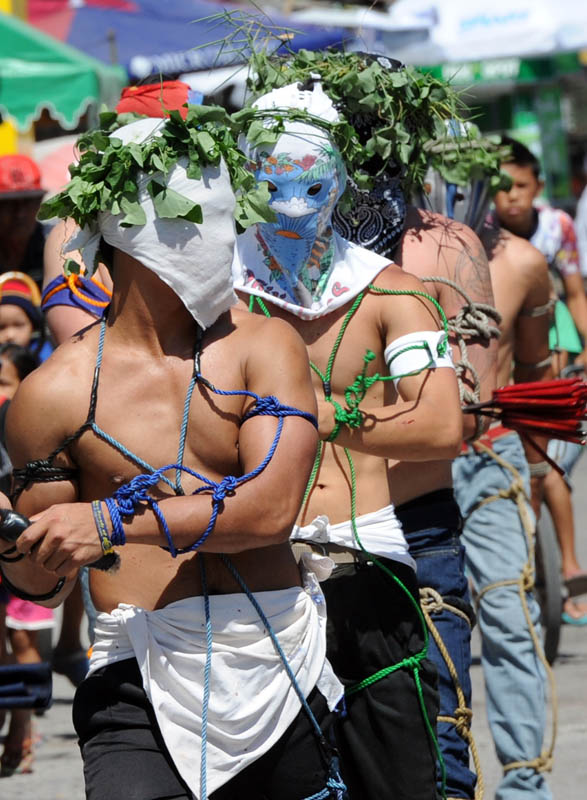 Penitents flagellate themselves as they participate in symbolic ceremonies which commemorate Jesus Christ's crucifixion and resurrection on Holy Thursday in Angeles City, Pampanga province north of Manila on March 28, 2013.  Crucifixions and self-flagellations are among the grisliest, but by no means the only extreme acts of penitence on show in the Philippines, one of Asia's largest Catholic outpost with about 75 million followers.   AFP PHOTO/TED ALJIBE