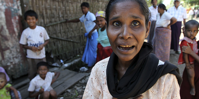 Muslims gather near their residences at Aung Mingalar ward in Sittwe, capital of Rakhine State, western Myanmar, Saturday, Oct. 27, 2012. Western Myanmar appeared calm Saturday after almost a week of deadly ethnic strife, a government spokesman said as human rights groups called for action to end the violence that one said it has documented with satellite imagery. Rakhine state spokesman Win Myaing there were no immediate reports of fresh clashes between the Buddhist Rakhine and the Muslim Rohingya communities. (AP Photo/Khin Maung Win)