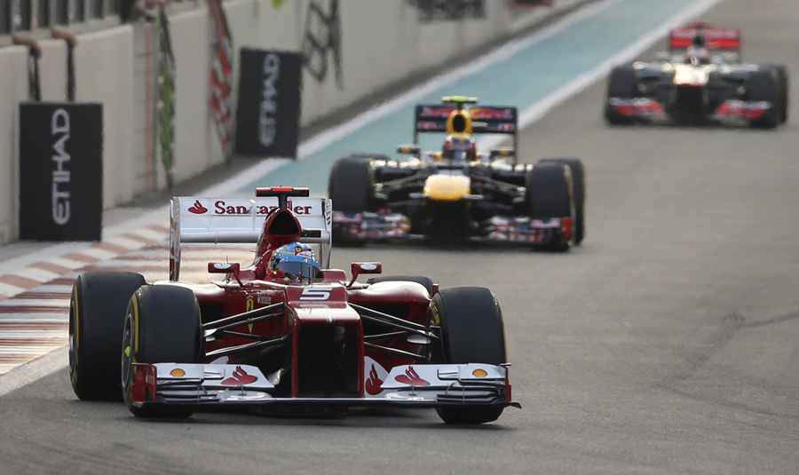 Ferrari driver Fernando Alonso of Spain leads Red Bull driver Mark Webber of Australia and Red Bull driver Mark Webber of Australia, during the Emirates Formula One Grand Prix, at the Yas Marina racetrack, in Abu Dhabi, United Arab Emirates, Sunday, Nov. 4, 2012. (AP Photo/Luca Bruno)