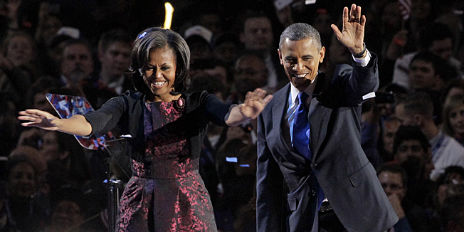 President Barack Obama along with first lady Michelle Obama acknowledge the crowd at his election night party Wednesday, Nov. 7, 2012, in Chicago. President Obama defeated Republican challenger former Massachusetts Gov. Mitt Romney. (AP Photo/Nam Y. Huh) 