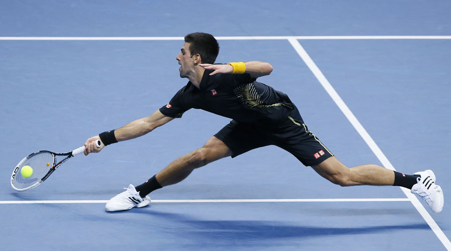 Novak Djokovic of Serbia stretches as he plays a return to Roger Federer of Switzerland during their ATP World Tour Tennis singles final match in London, Monday, Nov.  12, 2012. (AP Photo/Kirsty Wigglesworth)