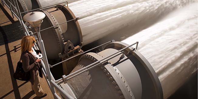 In this photo provided by the Bureau of Reclamation, water rushes from the Glen Canyon Dam as part of an experiment aimed at building beaches and sandbars on the Colorado River through the Grand Canyon, from the dam near Page, Ariz. The experiment is part of a government program to restore the Grand Canyon's ecosystem. (AP Photo/Bureau of Reclamation)