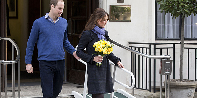 FILE- In this Thursday, Dec. 6, 2012 file photo, Britain's Prince William stand next to his wife Kate, Duchess of Cambridge as she leaves the King Edward VII hospital in central London. Prince William and his wife Kate are expecting their first child, and the Duchess of Cambridge was admitted to hospital suffering from a severe form of morning sickness in the early stages of her pregnancy.  King Edward VII hospital says a nurse involved in a prank telephone call to elicit information about the Duchess of Cambridge has died. The hospital said Friday, Dec. 7, 2012 that Jacintha Saldanha had been a victim of the call made by two Australian radio disc jockeys. They did not immediately say what role she played in the call.   (AP Photo/Alastair Grant, File)