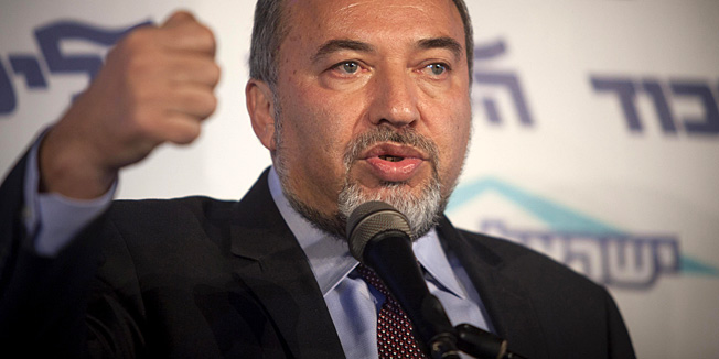 Israel's Foreign Minister Avigdor Lieberman speaks to the media during an event in Tel Aviv, Israel, Thursday, Dec. 13, 2012.  Israels powerful foreign minister resisted calls to resign after he was charged Thursday with breach of trust for actions that allegedly compromised a criminal investigation into his business dealings, throwing the country's election campaign into disarray just weeks before the vote.  (AP Photo/Dan Balilty)