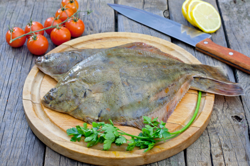 Flounder raw fish on cutting board