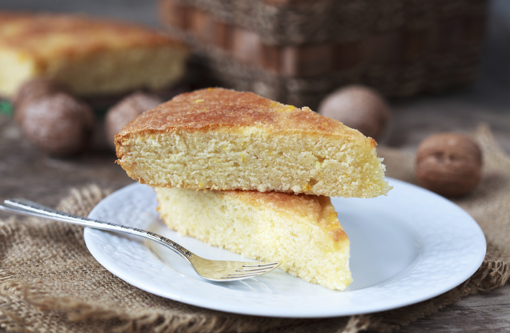 A piece of traditional Greek yoghurt cake Yaourtopita with orange zest in a rustic style, selective focus on top piece