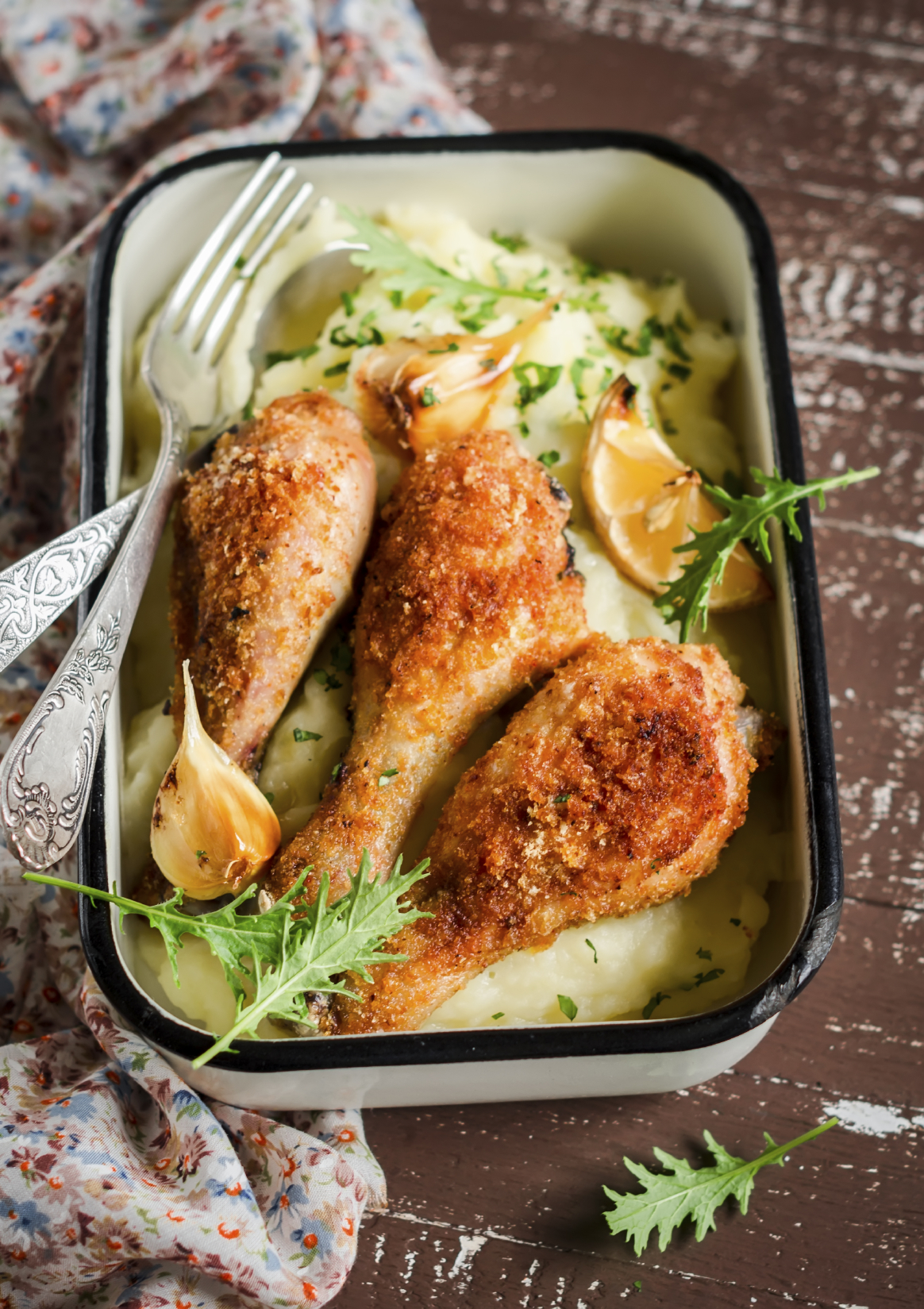 fried chicken drumstick and mashed potatoes on a dark wooden background