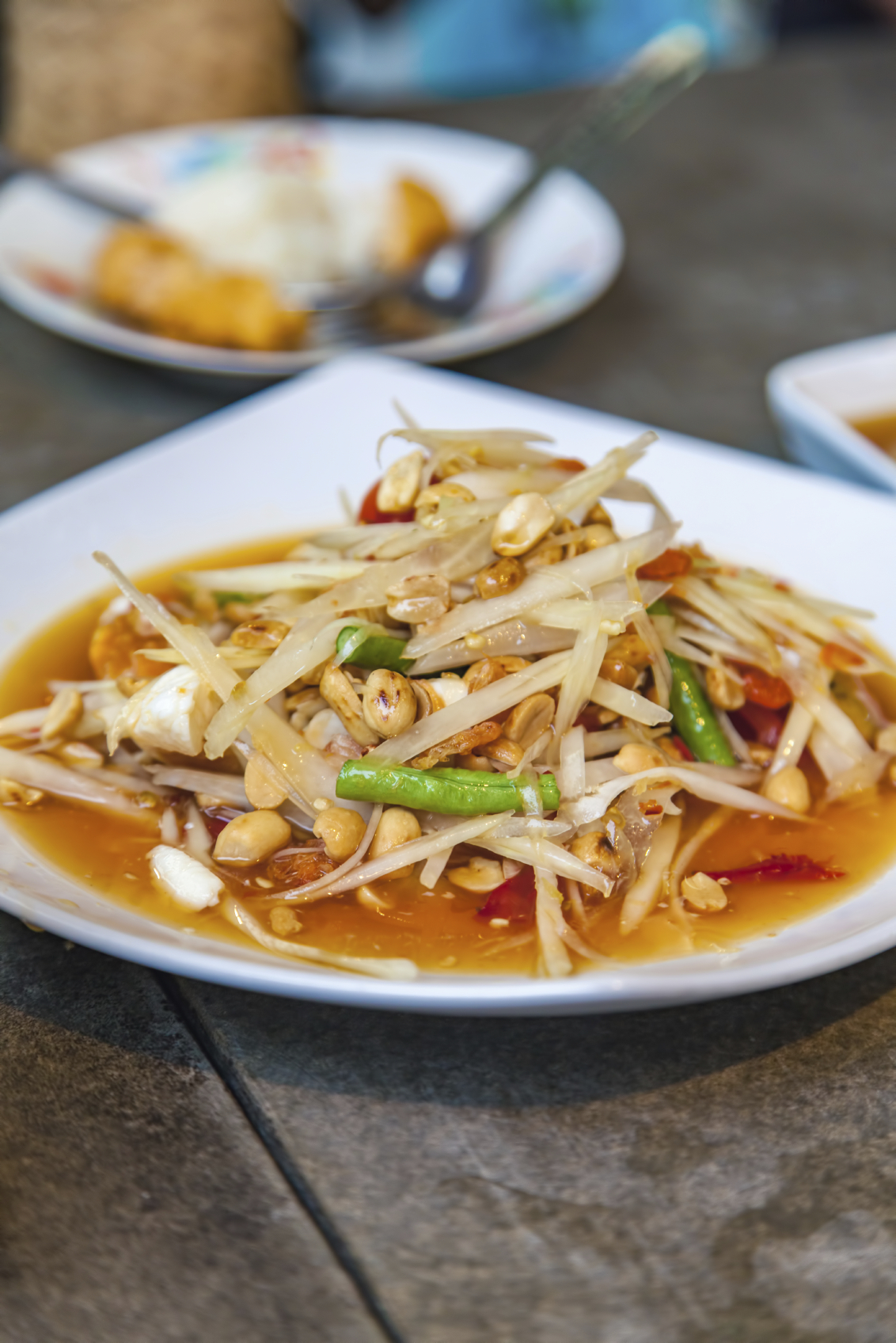 Fresh made papaya salad Som Tam, carrot and peanuts. Traditional thai cuisine.