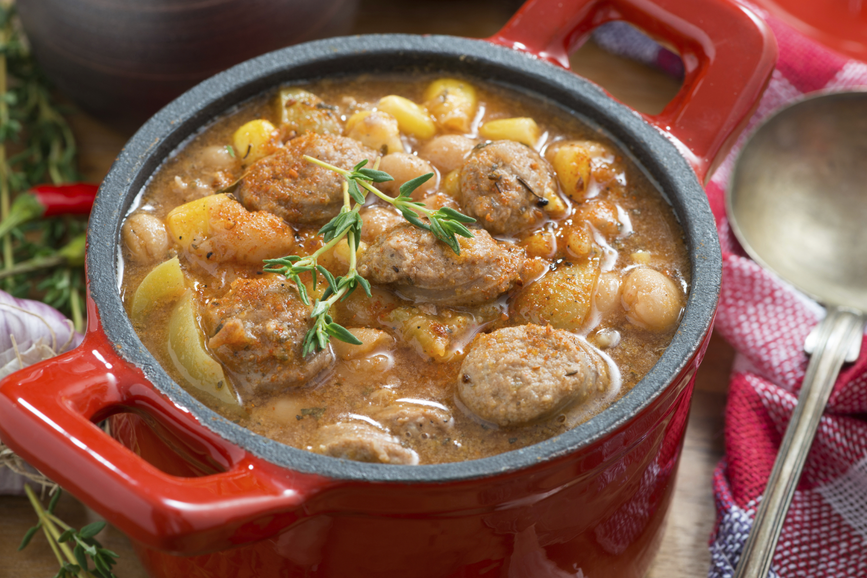vegetable stew with sausages in a pan, close-up, top view