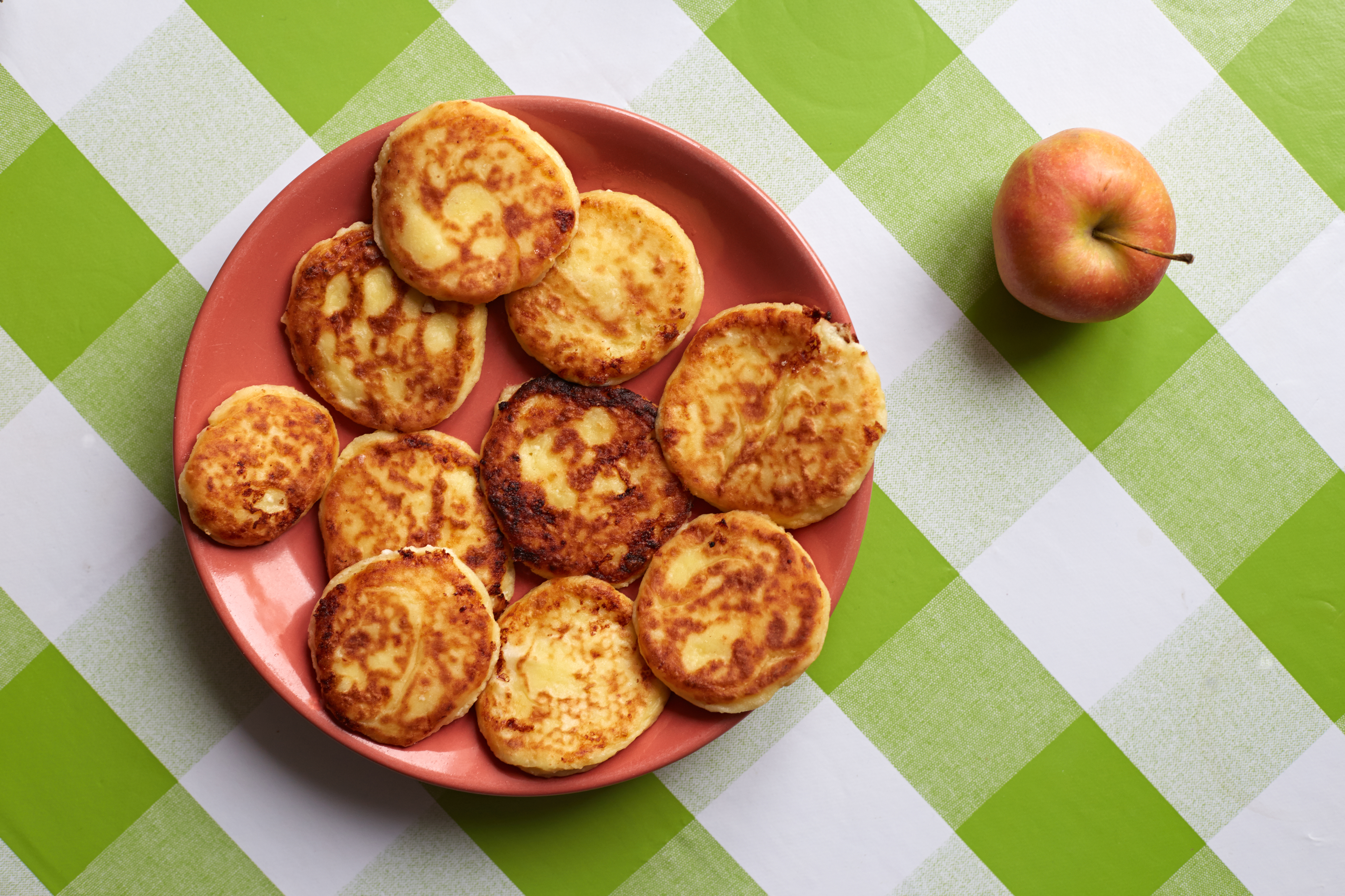 cottage cheese pancakes on the plate and checkered tablecloth