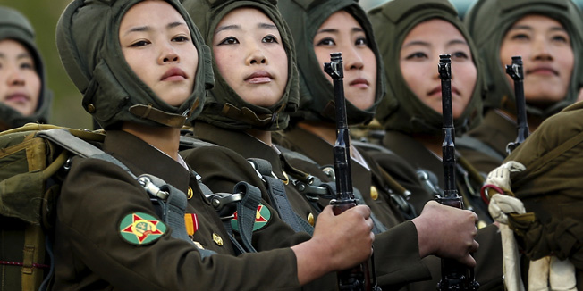 Soldiers look towards a stand with North Korean leader Kim Jong Un and other officials during the parade celebrating the 70th anniversary of the founding of the ruling Workers' Party of Korea, in Pyongyang October 10, 2015. Isolated North Korea marked the 70th anniversary of its ruling Workers' Party on Saturday with a massive military parade overseen by leader Kim Jong Un, who said his country was ready to fight any war waged by the United States.   REUTERS/Damir Sagolj  - RTS3VYF