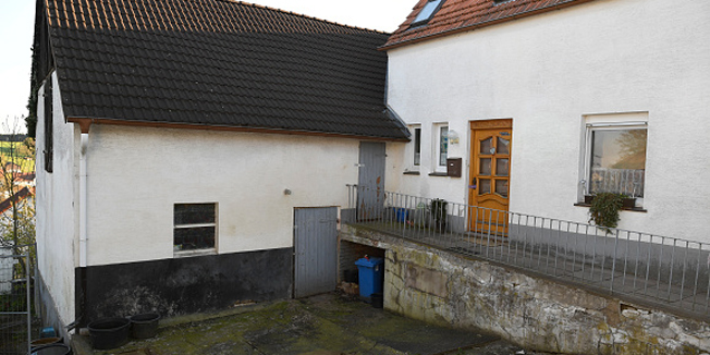 HOXTER, GERMANY - MAY 02: The residence of Wilfried W., 46, and his wife, Angelika B., 47, who are accused of imprisoning and murdering a 41-year-old woman, stands surrounded by a police fence during sunset on May 2, 2016 in Bosseborn village near Hoexter, Germany. According to media reports the couple has admitted to a second murder, also of a woman, and police are scheduled to provide more information in a press conference tomorrow. Police recently arrested the couple on charges of having imprisoned and tortured a 41-year-old woman over a two-month period before murdering her. (Photo by Alexander Koerner/Getty Images)